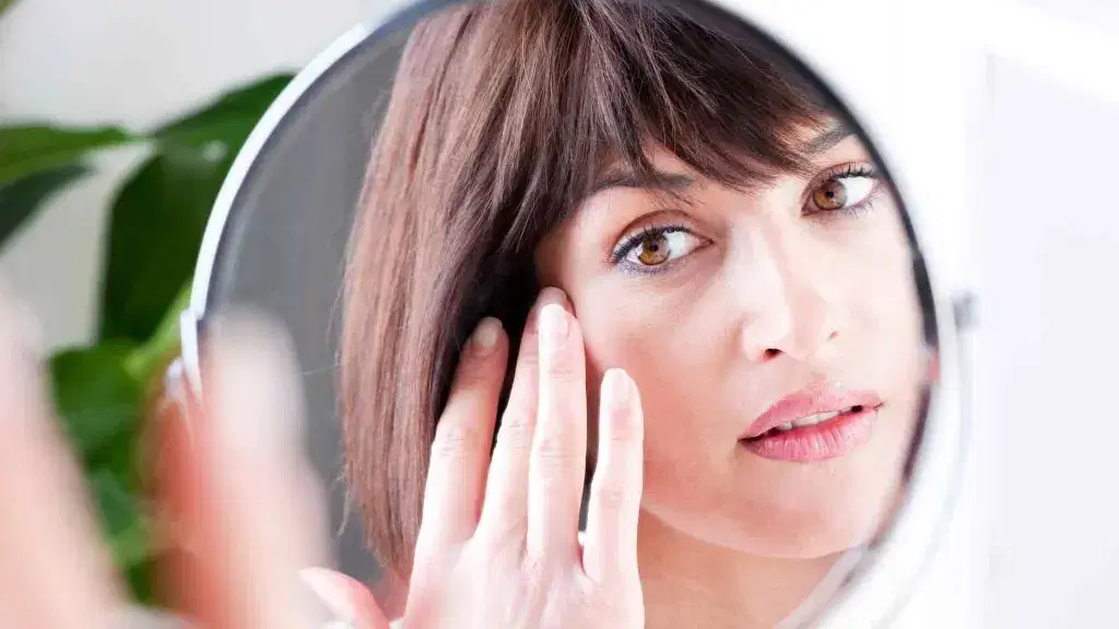 woman looking at the mirror