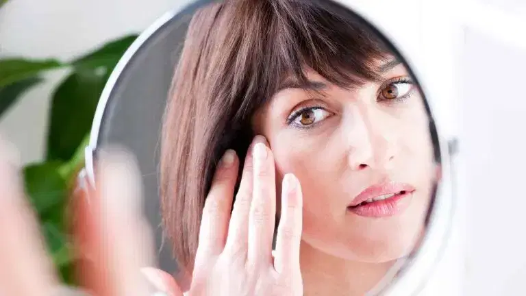 woman looking at the mirror